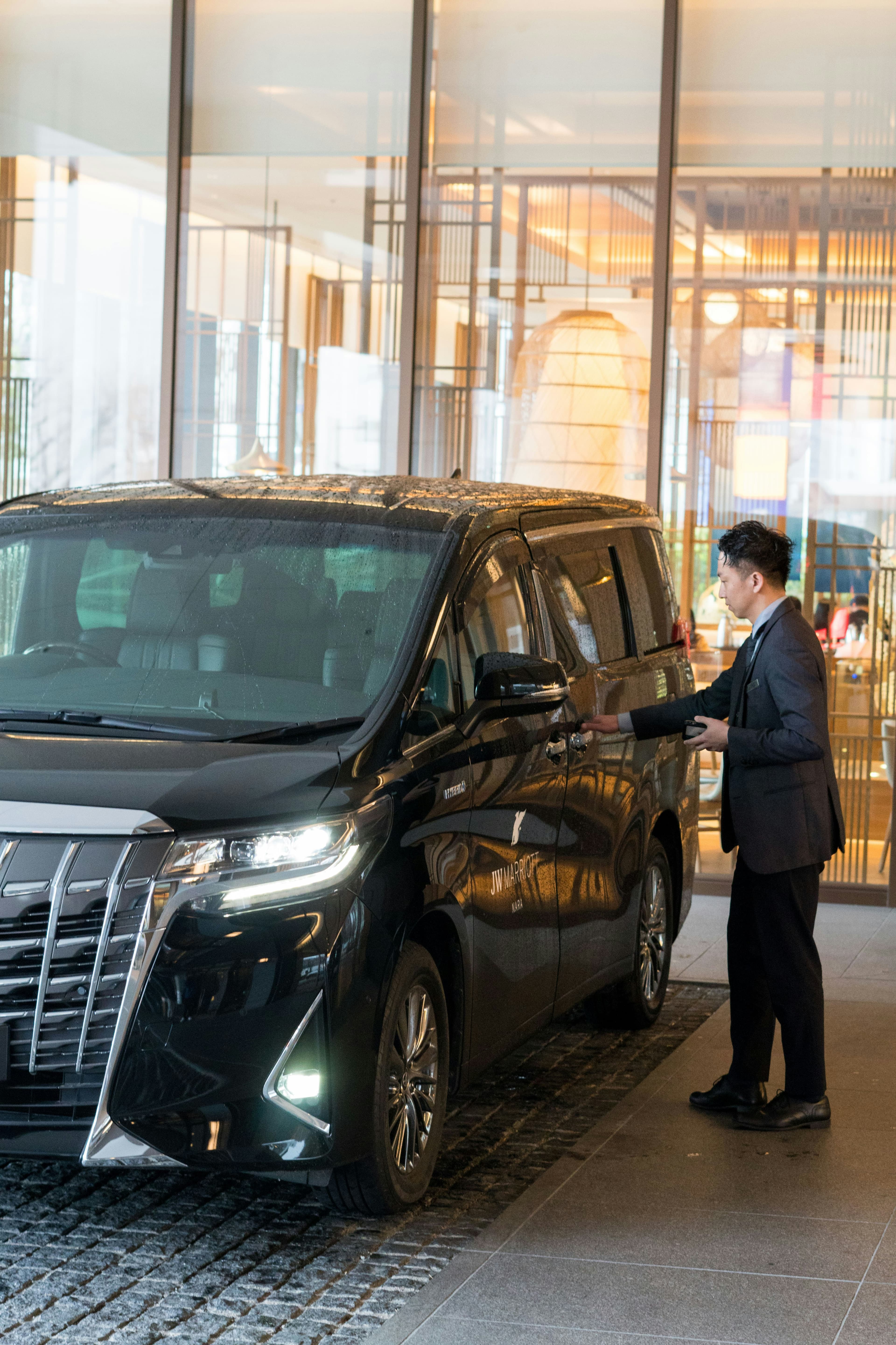 Luxury black sedan dropping off VIP guests at a Las Vegas casino entrance with valet service